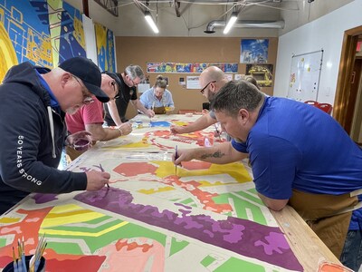 Employees painting in the Collaboration Room
