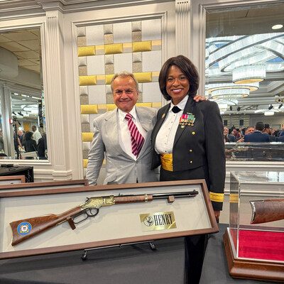 Rear Admiral Zeita Merchant, Commander, Personnel Service Center (PSC), U.S. Coast Guard, receiving her custom-engraved and hand-painted Henry rifle in honor of the NPDF Woman of the Year Award. (Henry Repeating Arms)
