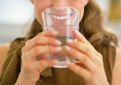 Woman drinking tap water