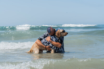 A special ceremony is being held at the 2025 Surf Dog Surf-A-Thon to recognize Surf Dog legend Derby California, here seen with his owner, Kentucky.