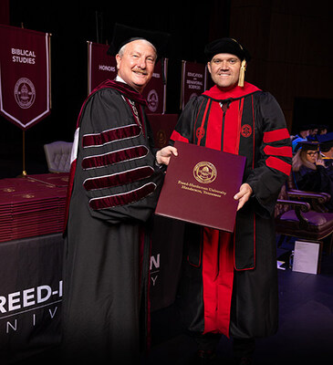FHU President David R. Shannon presents Keith Harris with his doctorate in ministry in May 2025. FHU President David R. Shannon presents Keith Harris with his doctorate in ministry in May 2025.